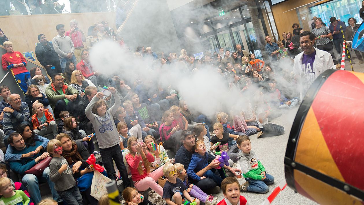 Smoke coming our from a smoke canon in front of a large crowd